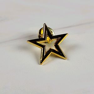 Gold tone open star pin